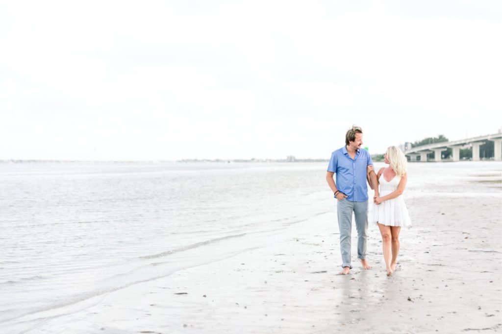 The happy couple couldn't contain their excitement after the 4th of July surprise proposal lead to an engagement! Gorgeous bridge in the background at Clearwater beach in Florida. #surpriseproposal #4thofjuly #independencedayengagement #familyandfriends #floridabeach #beachproposal #proposaldetails #proposal #marryme #shesaidyes #redwhiteandblueproposal