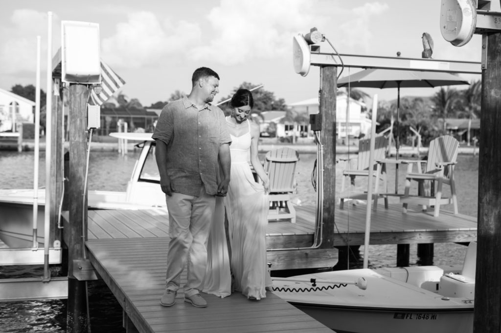 Bride and Groom walking on the dock of their backyard wedding.