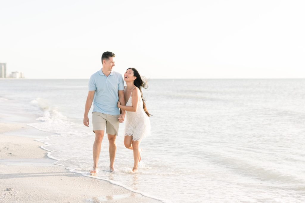 Couple is walking on the beach happily.