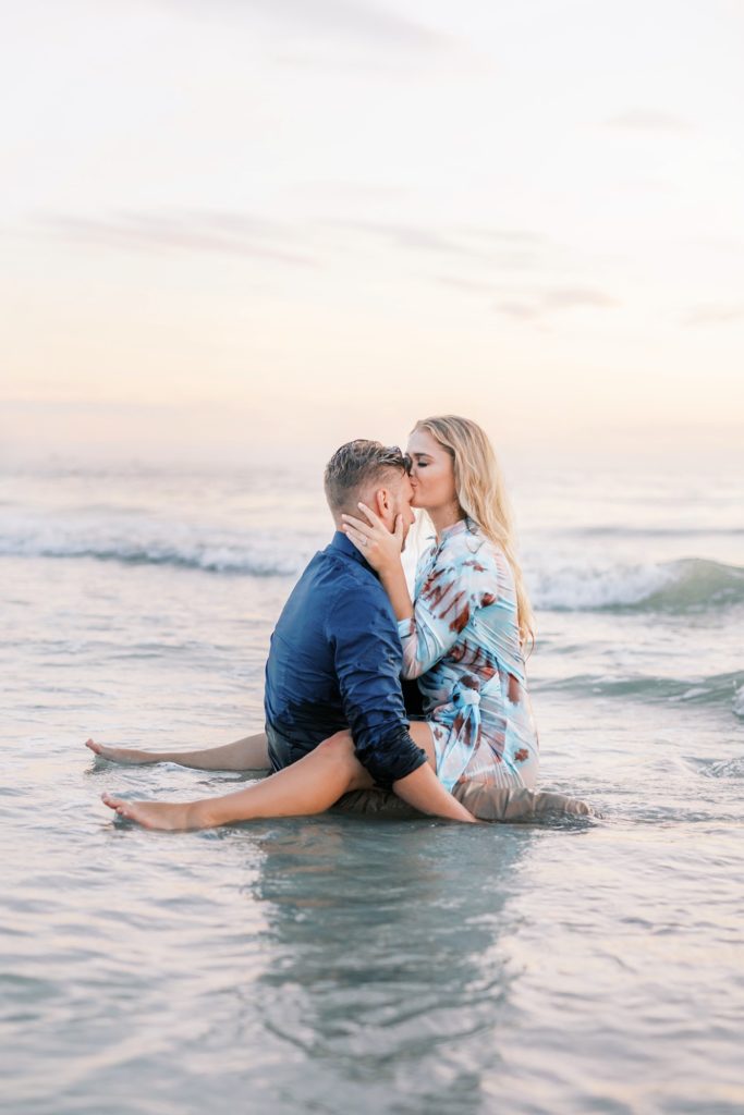 Dreamy couple kissing forehead on the beach.