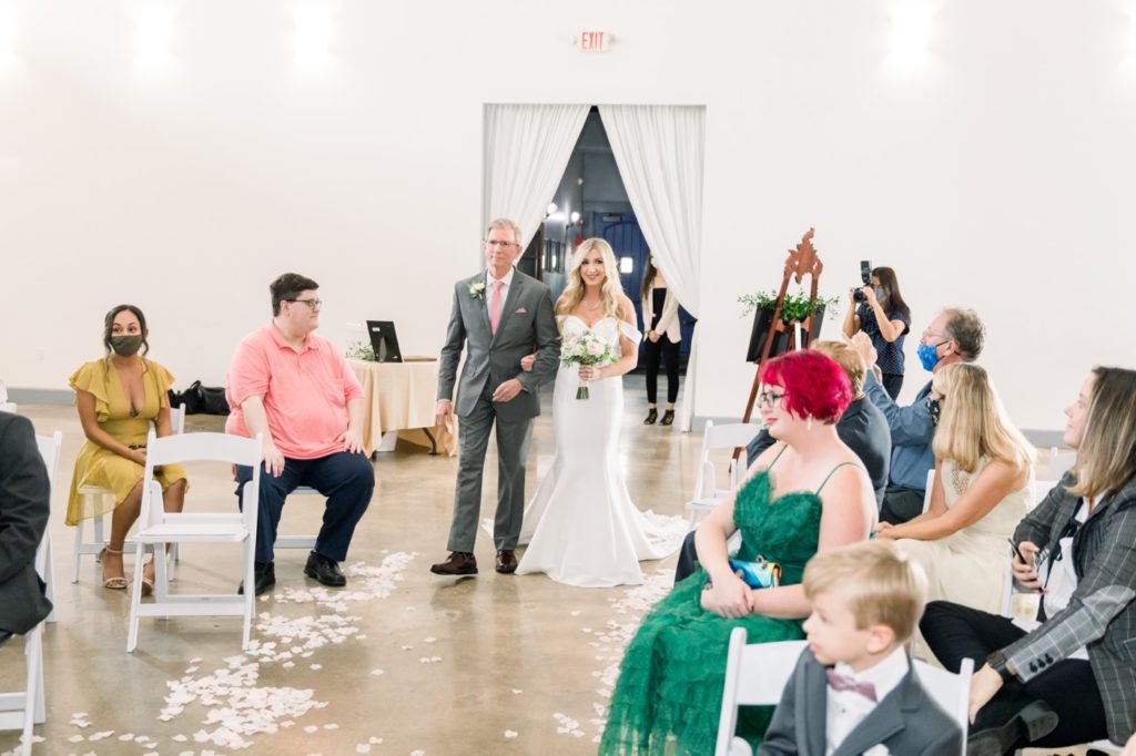 Bride is walking down the aisle inside Rialto Theatre Wedding Venue Downtown Tampa