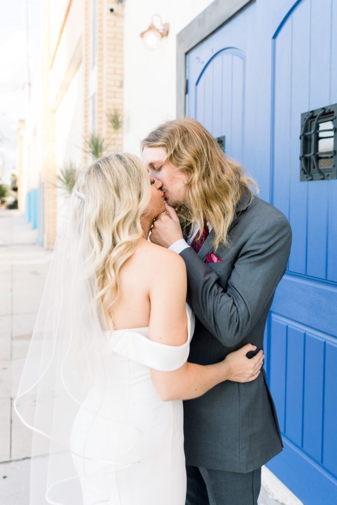 Bride and grooms are kissing outside Rialto Theatre Wedding Venue Downtown Tampa