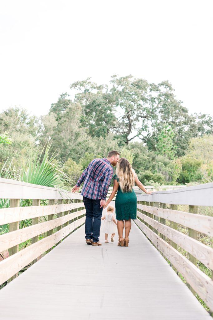 Mom and dad kiss on the bridge in Kapok Park
