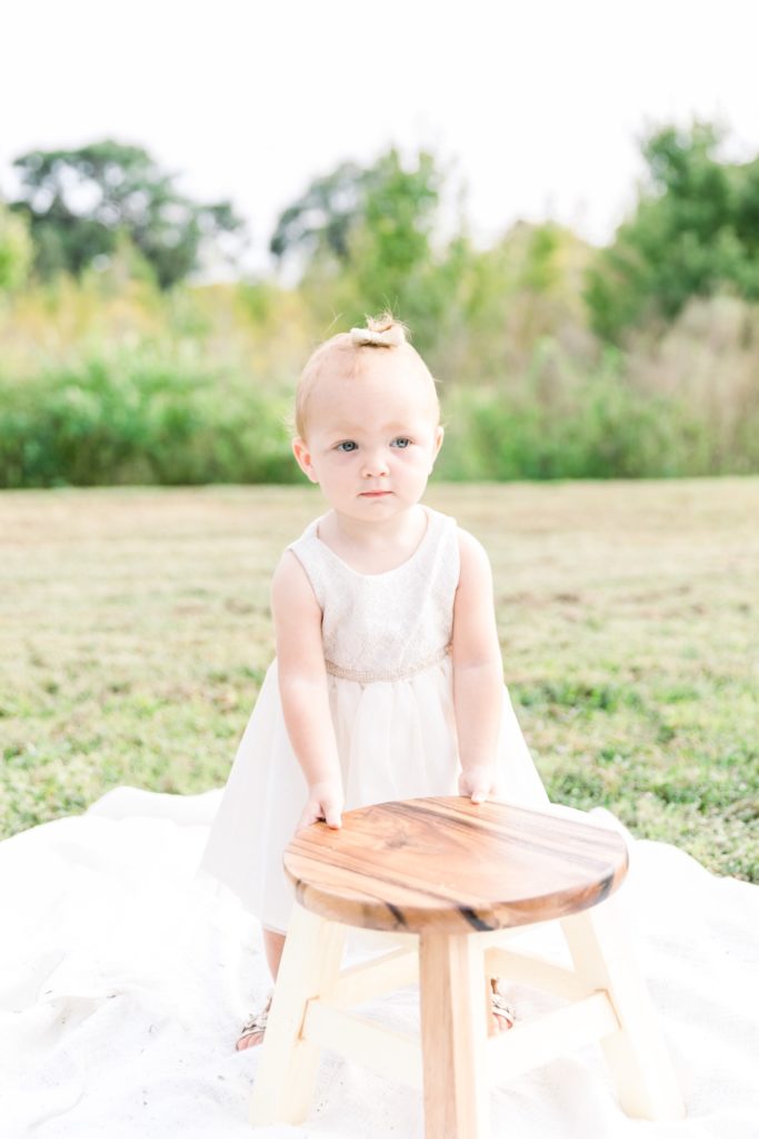 Little girl in the white dress at the park.