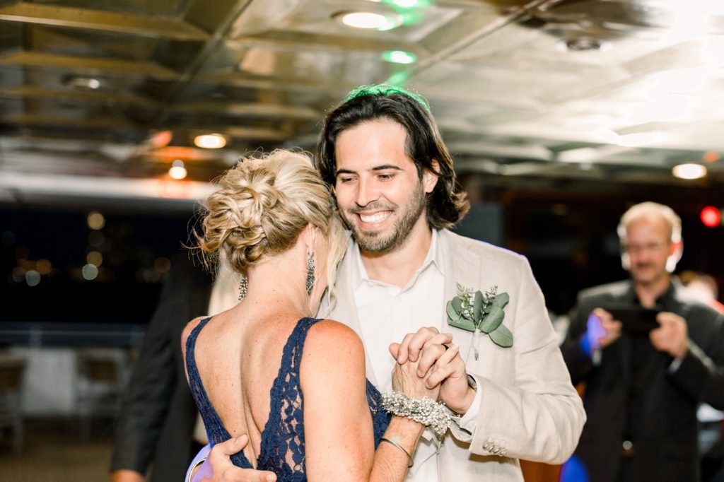 Mom and groom dance on the Yacht StarShip IV Sunset Cruise