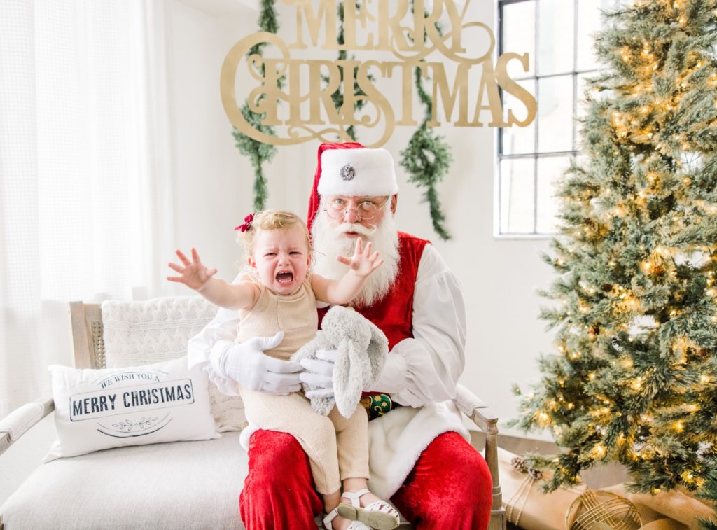 A girl was crying  in the Santa Mini Sessions for Holiday photos