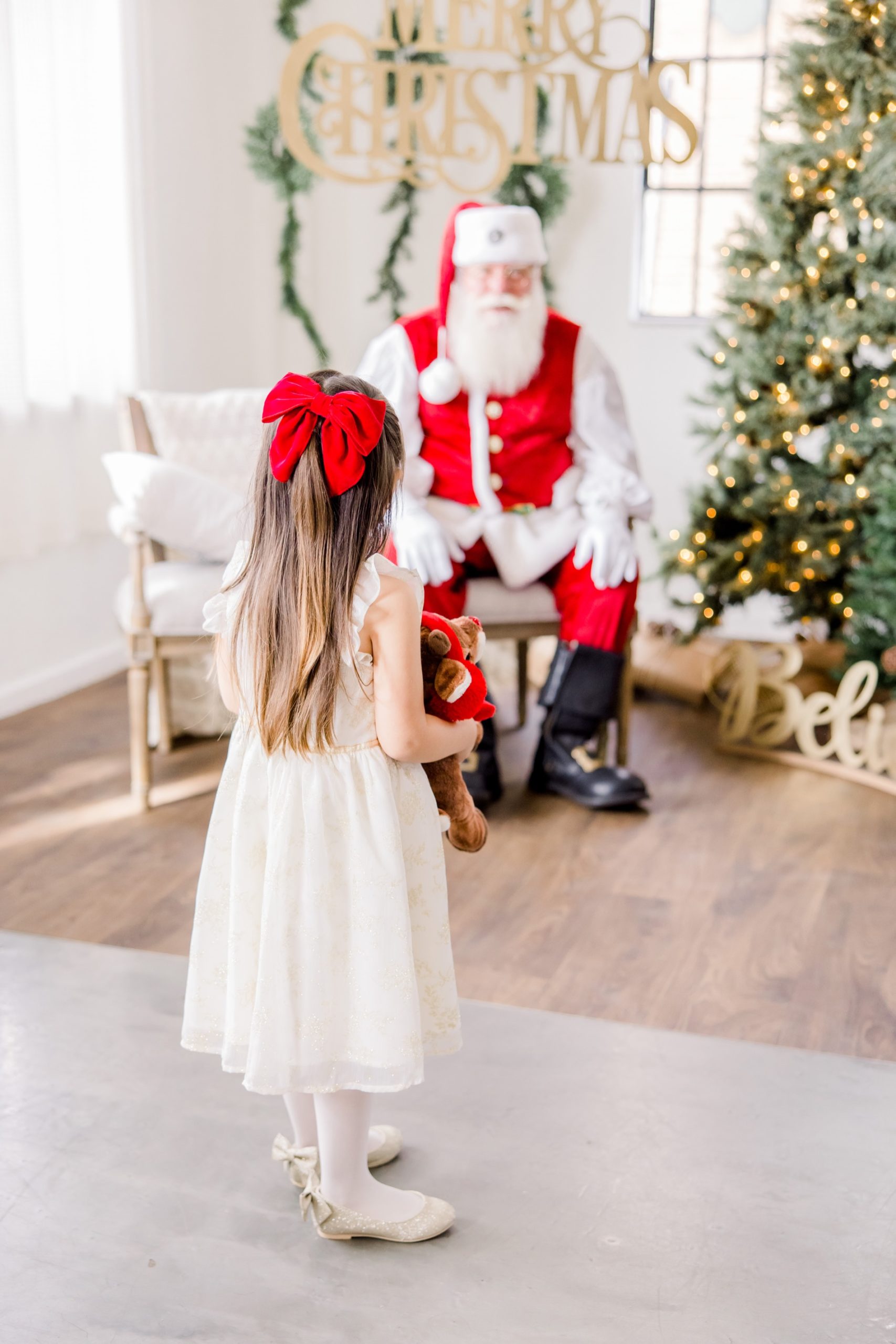 A girl with Santa on Holiday mini Session