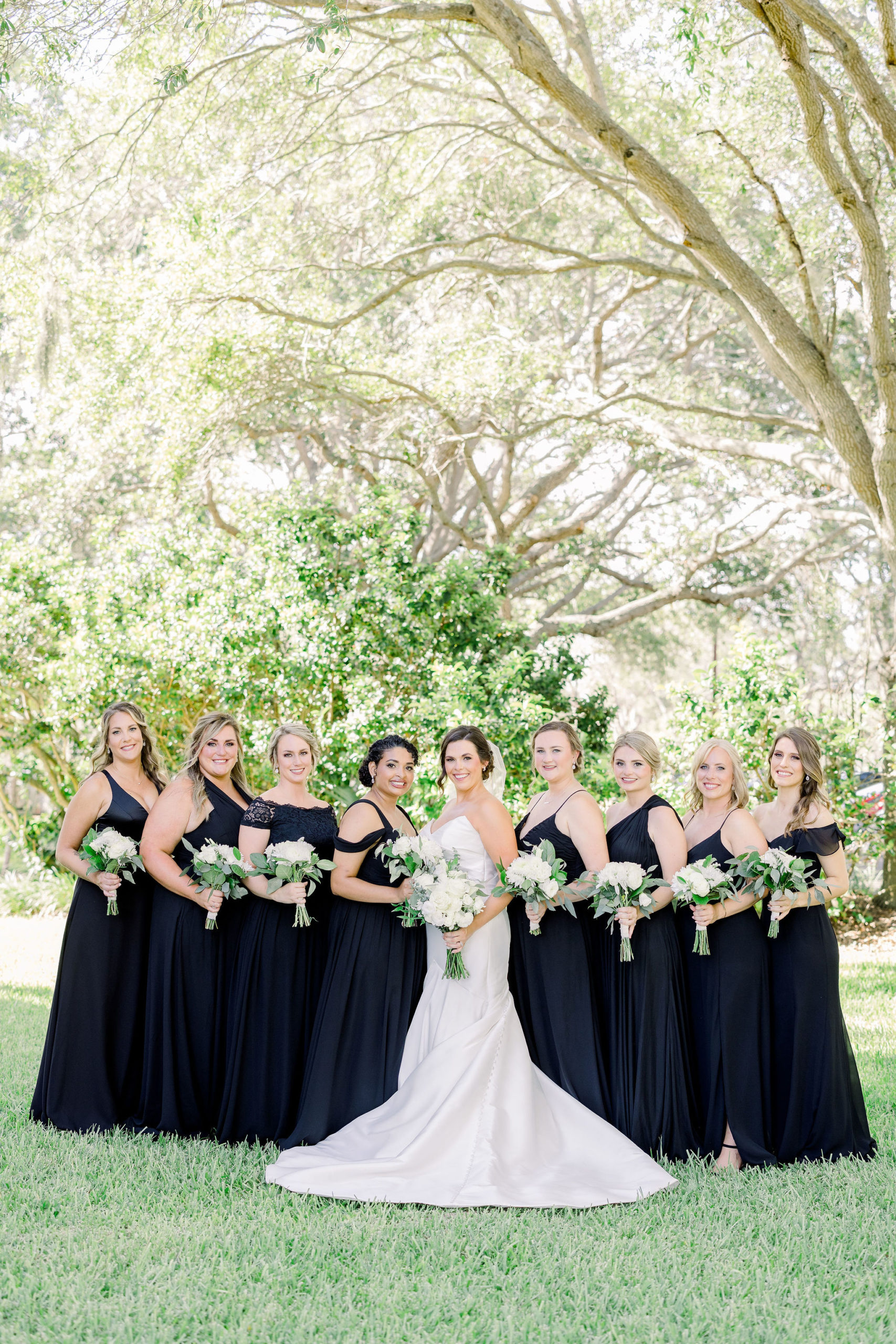 Wedding photographer Jommy Photography captures a portrait of a bride with her bridesmaids with black and white color scheme. Bridal photography at IMG Golf Course in Bradenton by Jommy Photography.
