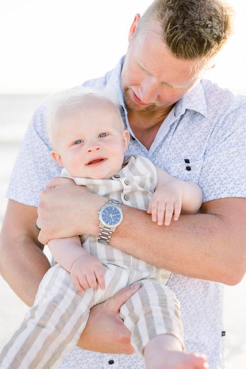 A father holding his baby boy in his arms during a family session with Jommy Photography in Florida. dad and lad #JommyPhotography #JommyFamilies #FloridaFamilyPhotography #Familyphotographers #professionalphotographers #familyportraits