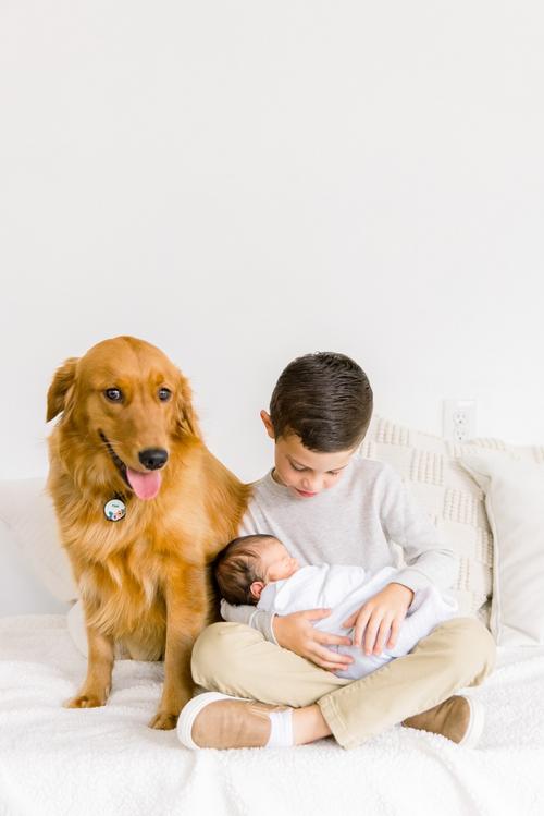 Jommy Photography captures a dog with a big and little brother at a studio in Florida. dog with boys studio #JommyPhotography #JommyFamilies #FloridaFamilyPhotography #Familyphotographers #professionalphotographers #familyportraits