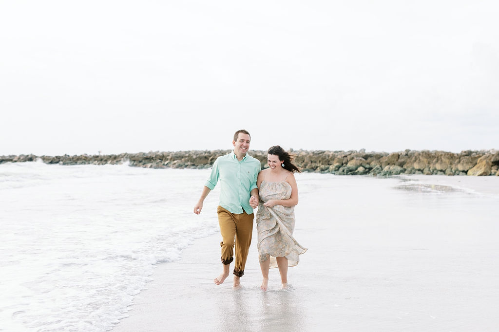 A couple walks in the waves on the beach during an engagement session with Jommy Photography. waves couples #JommyPhotography #JommyEngagements #BeachEngagements #FloridaEngagements #FloridaBeachEngagements #ClearwaterFlorida #EngagementPhotographer
